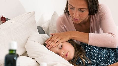 mother checking on sick child